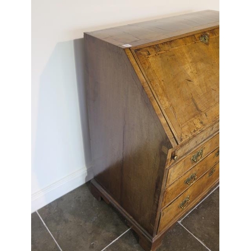 71 - A George 1st walnut bureau with a well and stepped fitted interior above two small and two long draw... 