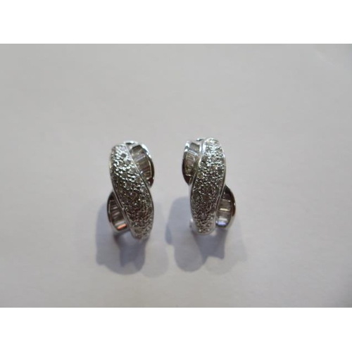 718 - A pair of 18ct white gold diamond earrings marked 18K 750, 2cm in length, approx 8 grams, in good co... 