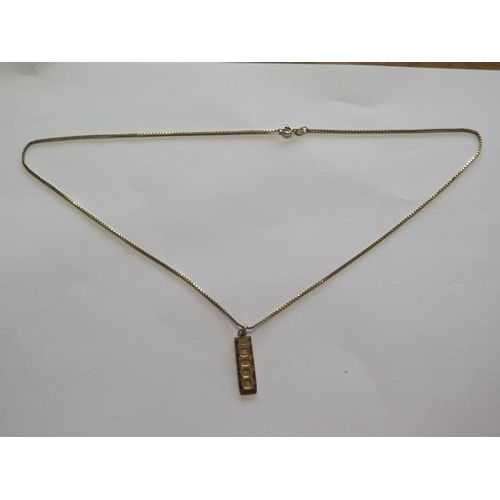 724 - A hallmarked 9ct yellow gold ingot on a 9ct hallmarked box chain, chain 55cm long, approx 8.1 grams,... 