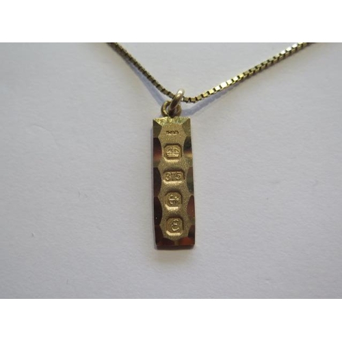 724 - A hallmarked 9ct yellow gold ingot on a 9ct hallmarked box chain, chain 55cm long, approx 8.1 grams,... 