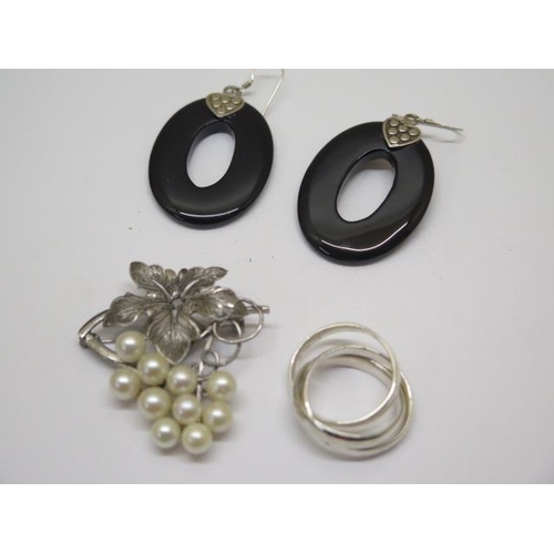 733 - A pair of silver and black onyx drop earrings, a silver Russian style ring and a silver and pearl br... 