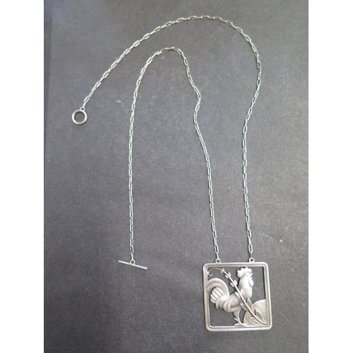 738 - A Georg Jensen sterling silver cockerel pendant on chain, 62cm long, pendant 38mm wide, No; 96, desi... 