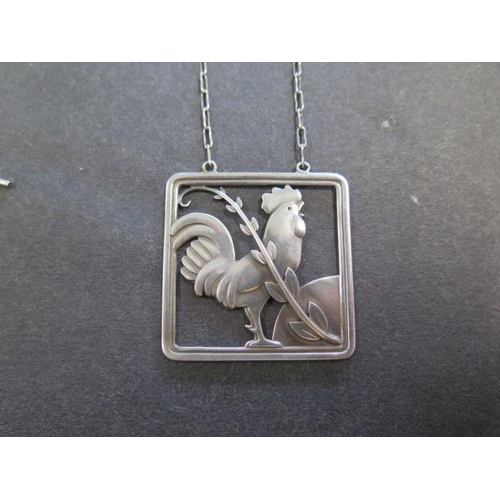 738 - A Georg Jensen sterling silver cockerel pendant on chain, 62cm long, pendant 38mm wide, No; 96, desi... 