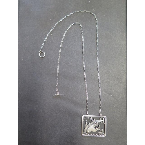 741 - A Georg Jensen sterling silver dolphin pendant on a chain, 61.5cm long, pendant 37mm wide, in genera... 