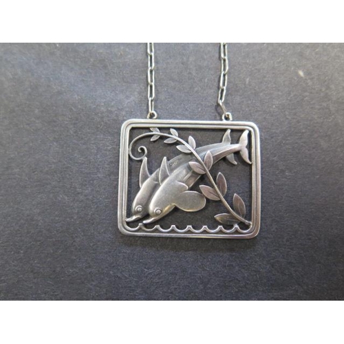 741 - A Georg Jensen sterling silver dolphin pendant on a chain, 61.5cm long, pendant 37mm wide, in genera... 