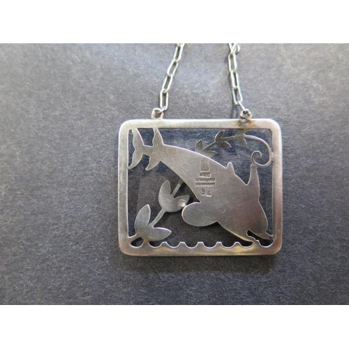 741 - A Georg Jensen sterling silver dolphin pendant on a chain, 61.5cm long, pendant 37mm wide, in genera... 