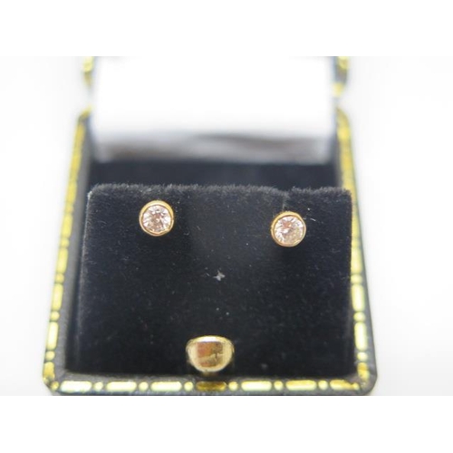 746 - A pair of 18ct yellow gold and diamond stud earrings, each approx 0.06ct