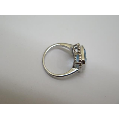 753 - A 9ct hallmarked white gold Art Deco style blue topaz and diamond ring, size M, head approx 16mm x 1... 