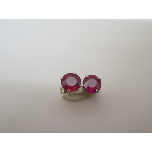 755 - An pair of 18ct white gold ruby stud earrings, approx 1.5ct, hallmarked, in good condition