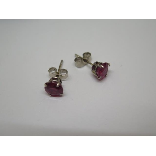 755 - An pair of 18ct white gold ruby stud earrings, approx 1.5ct, hallmarked, in good condition