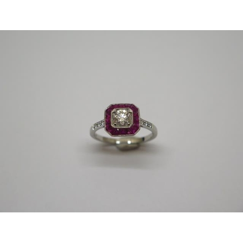 757 - A quality platinum Art Deco style ruby and diamond ring, with diamond shoulders, centre diamond appr... 