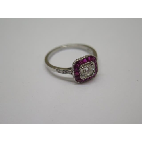 757 - A quality platinum Art Deco style ruby and diamond ring, with diamond shoulders, centre diamond appr... 