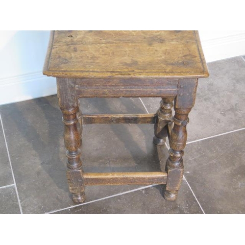 76 - An 18th century oak joint stool, 57cm tall x 45cm x 27cm, with wear consistent with age and later re... 