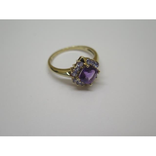 764 - A 9ct hallmarked yellow gold amethyst and tanzanite cluster ring, size R, head approx 12mm x 12mm, i... 