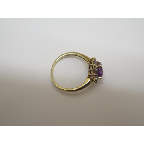 764 - A 9ct hallmarked yellow gold amethyst and tanzanite cluster ring, size R, head approx 12mm x 12mm, i... 