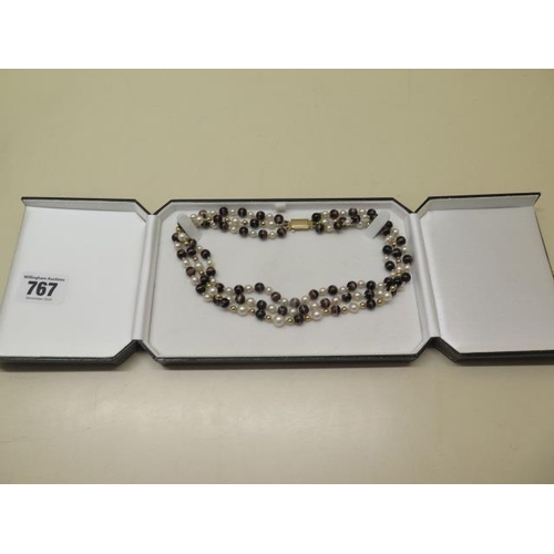 767 - A tiger eye, pearl and gold bead three strand necklace with a 9ct gold clasp, 38cm long, in good con... 