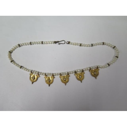 812 - A string of eastern pearls with 5 gilt metal drops, 42cm long