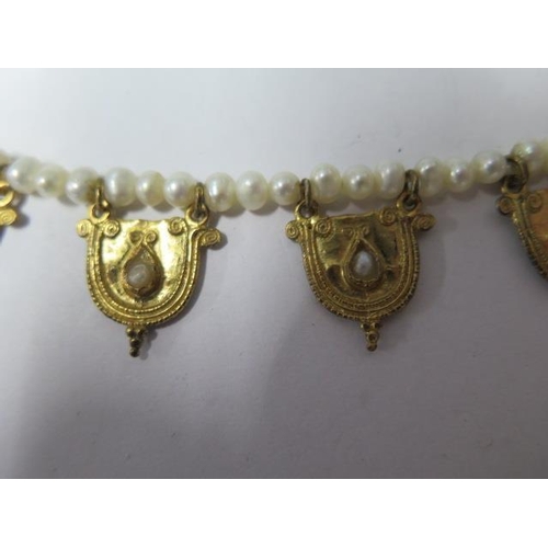 812 - A string of eastern pearls with 5 gilt metal drops, 42cm long