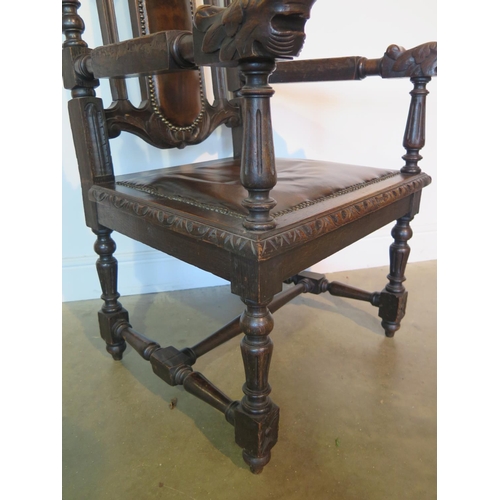 82 - A 19th century oak throne chair, the crested rail with carved lion and unicorn over a brown leather ... 