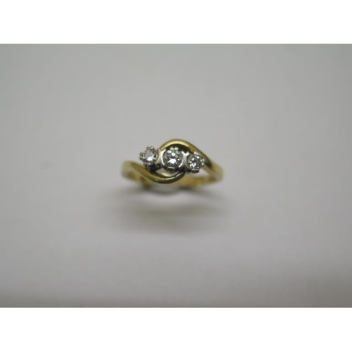 851 - A hallmarked 18ct yellow gold three stone diamond crossover ring, size K, approx 3 grams, some wear ... 