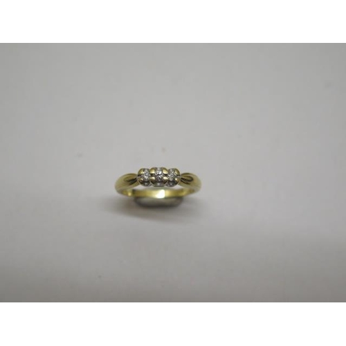 852 - A hallmarked 18ct yellow gold three stone diamond ring, size K, approx 3 grams, some wear but genera... 