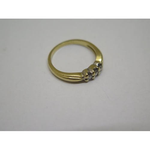 852 - A hallmarked 18ct yellow gold three stone diamond ring, size K, approx 3 grams, some wear but genera... 