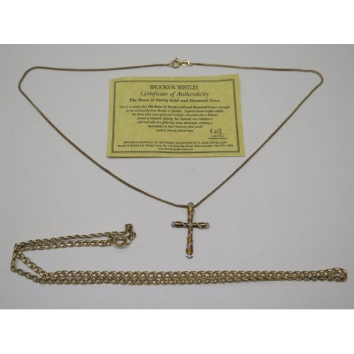 860 - A Brooks and Bently Peace and Purity 9ct yellow gold diamond cross on chain, and a 9ct 52cm chain, t... 