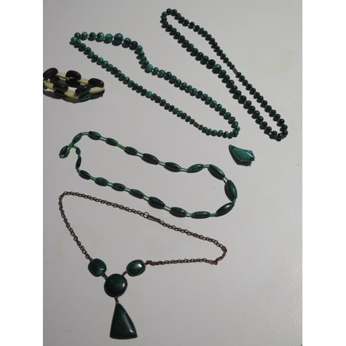 946 - Four malachite necklaces, a pendant and a bangle, longest necklace is 68cm with a 15mm diameter cent... 