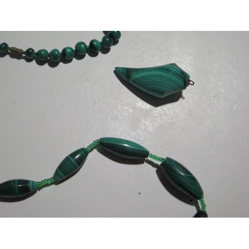 946 - Four malachite necklaces, a pendant and a bangle, longest necklace is 68cm with a 15mm diameter cent... 