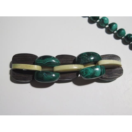 946 - Four malachite necklaces, a pendant and a bangle, longest necklace is 68cm with a 15mm diameter cent... 