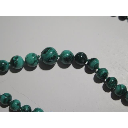 946 - Four malachite necklaces, a pendant and a bangle, longest necklace is 68cm with a 15mm diameter cent... 