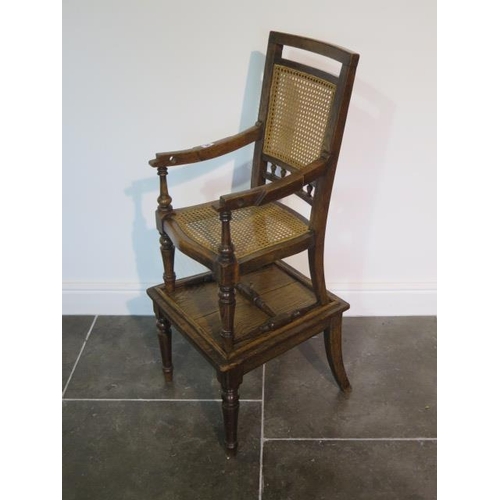 95 - A Victorian oak child's high chair on stand with Bergere cane seat and back, chair detaches from bas... 