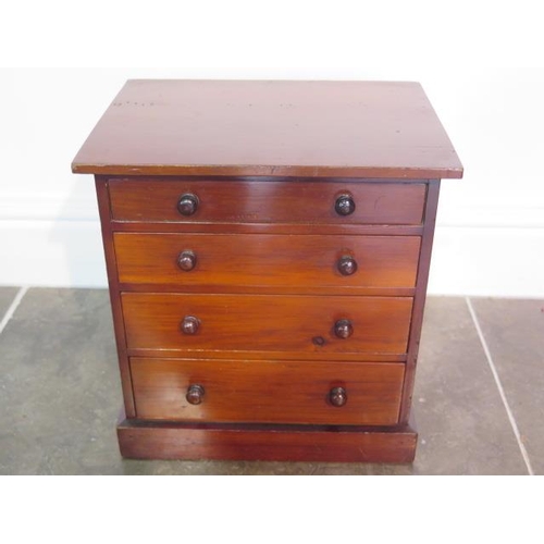 96 - A Victorian miniature chest of drawers of collectors chest of four graduated drawers with turned woo... 