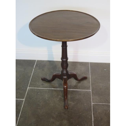 97 - A Georgian mahogany tripod wine table circular top with raised lip over a slim turned column and cab... 