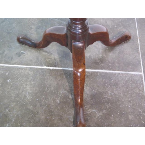 97 - A Georgian mahogany tripod wine table circular top with raised lip over a slim turned column and cab... 