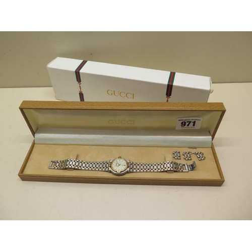 971 - A ladies Gucci bi-metal bracelet watch with spare links, not currently running and may need a new ba... 