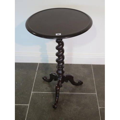 98 - A Victorian mahogany tripod table, the circular top with raised lip above a barley twist stem and ca... 