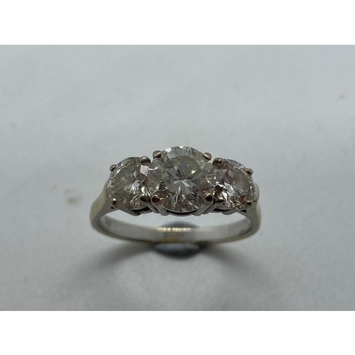 701 - An impressive 18ct white gold three stone diamond ring, the centre stone approx 1.9ct, side stones a... 