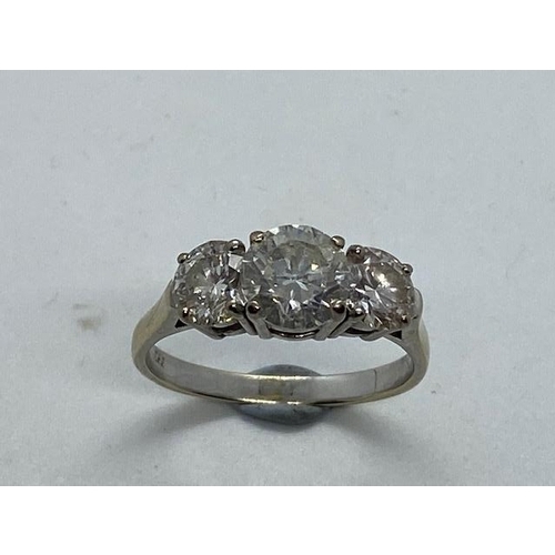 701 - An impressive 18ct white gold three stone diamond ring, the centre stone approx 1.9ct, side stones a... 