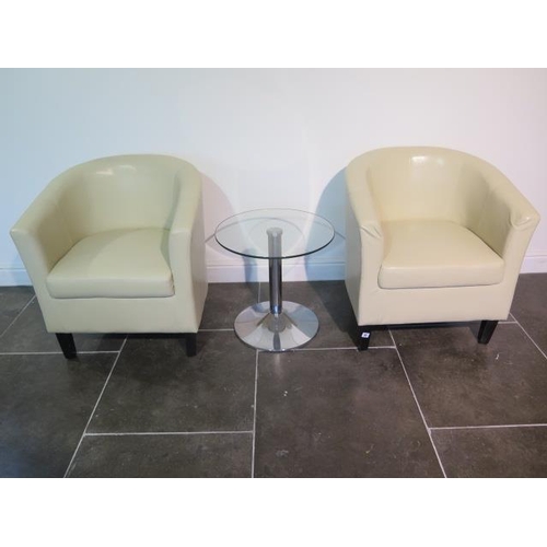 9 - A pair of faux leather cream tub chairs with a glass top coffee table, 49cm x 50cm, some usage marks... 