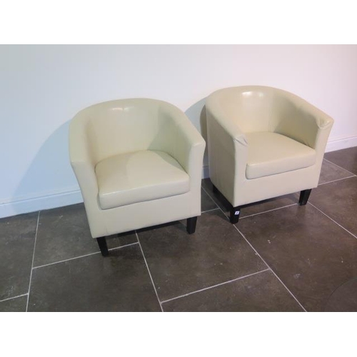 12 - A pair of faux leather cream tub chairs, some usage marks but generally good