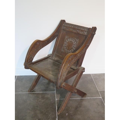 87 - A Victorian oak carved Abbotts chair, 90cm tall x 68cm wide x 70cm deep, general wear and expansion ... 