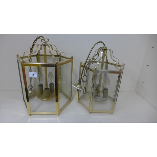 2 - A brass hexagonal hall lantern, 37cm x 25cm, and a similar smaller silvered lantern
