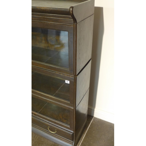 57 - A five piece glazed staking dark oak bookcase with a base drawer, 124cm tall x 87cm x 34cm, some bow... 