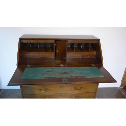 58 - A Georgian mahogany five drawer bureau on ogee bracket feet, 110cm tall x 116cm x 55cm, with a fitte... 