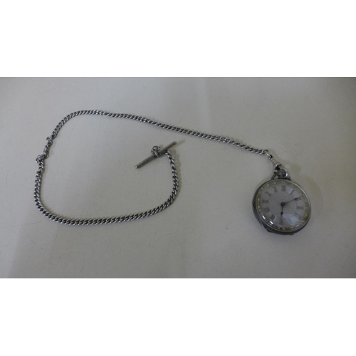 604 - A silver and gilt pocket watch and chain - approx weight 60 grams - no key but runs