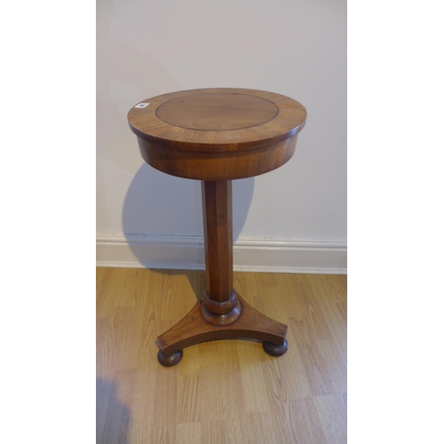 69 - A Victorian mahogany statue stand with a revolving top on a octagonal column and tripartite platform... 