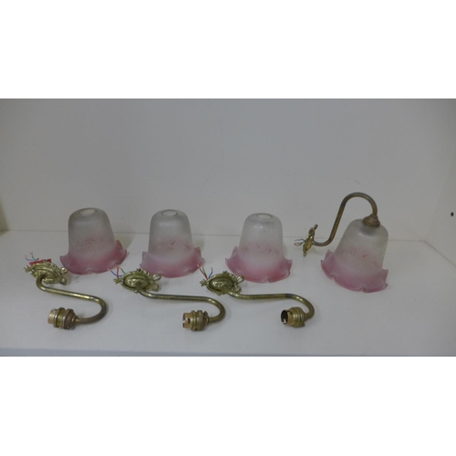 76 - Four brass wall lights with Cranberry tinted shades, shades 12cm x 13cm, all in generally good condi... 