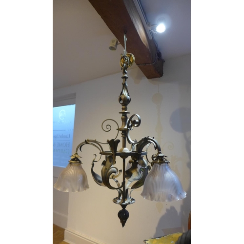81 - A country house brass acanthus leaf hanging ceiling light with three glass holophane shades, 100cm t... 