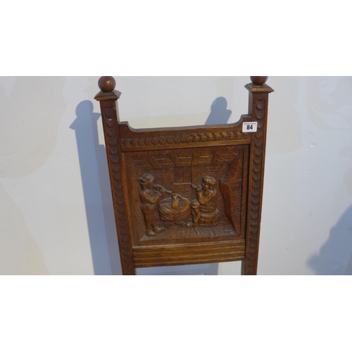 84 - A Victorian carved oak side chair with a carved back of musicians in a tavern, 108cm tall x 48cm wid... 